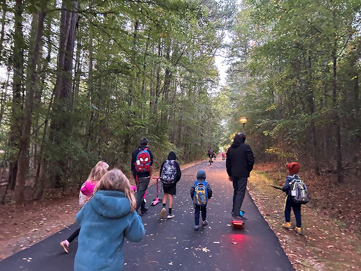 kids and parents walking and rolling to school along a trail